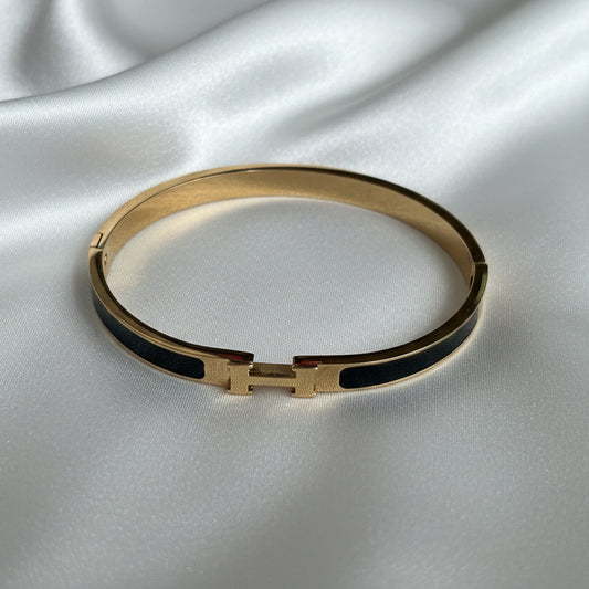 Classic Gold and Black Enamel Bangle – Iconic "H" Motif Hinged Bracelet