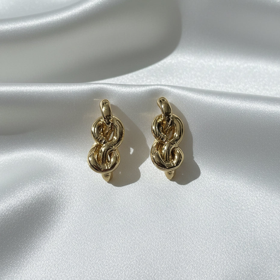 Elegance Unlinked: Twisted Gold Knot Statement Earrings